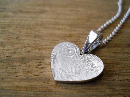 Heart necklace with leafy floral embossed pattern