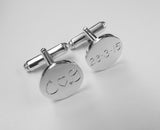 Round cufflinks engraved with initials and date