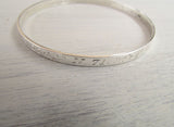 Bangle engraved with GPS coordinates