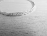 Bangle engraved with GPS coordinates