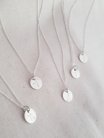 Disc necklace with cursive engraved initial